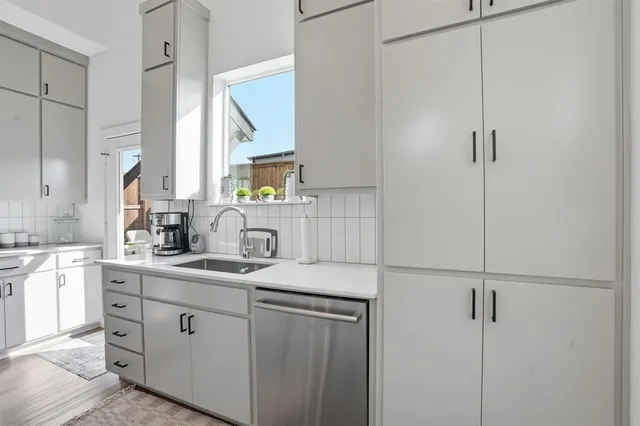 a kitchen with stainless steel appliances a sink stove refrigerator and cabinets
