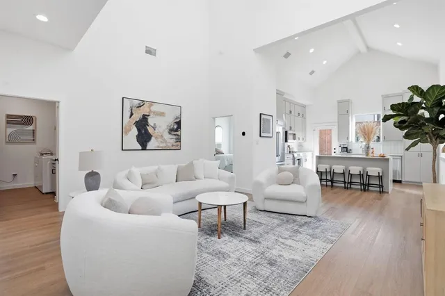 a kitchen with stainless steel appliances granite countertop a table chairs sink and cabinets