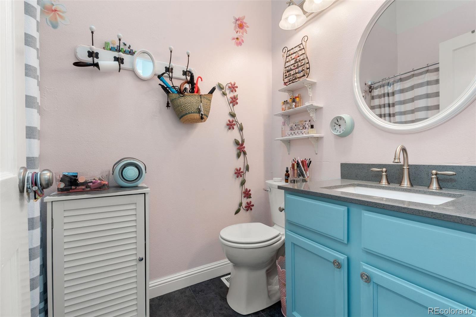 17467 East Rice Circle, Unit C Aurora, CO 80015 - Photo 16 of 25 a bathroom with a sink a toilet and a mirror