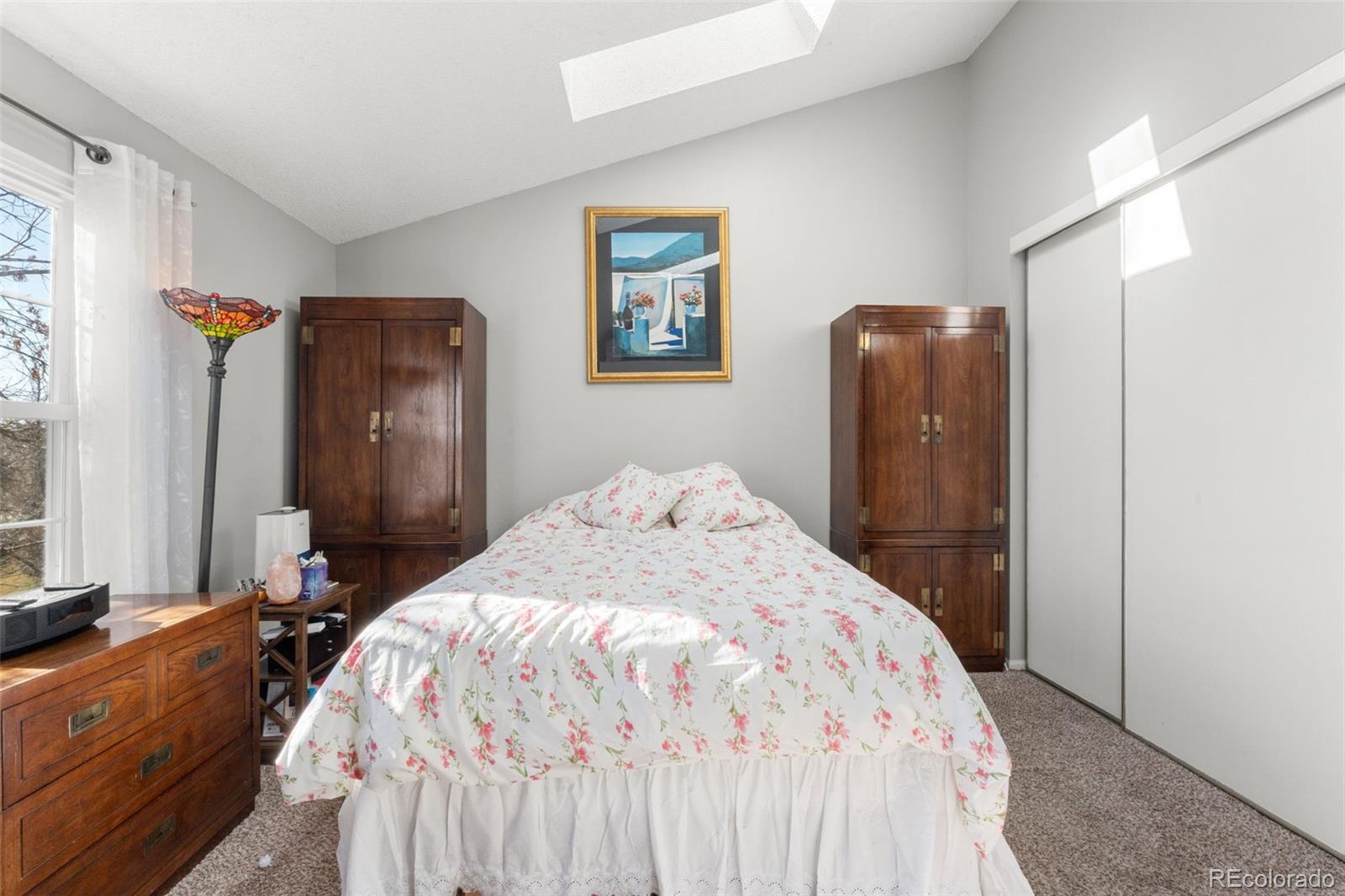 17467 East Rice Circle, Unit C Aurora, CO 80015 - Photo 18 of 25 a bedroom with a bed and a large mirror