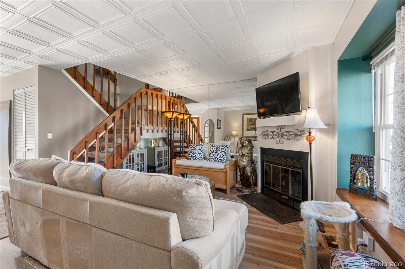 17467 East Rice Circle, Unit C Aurora, CO 80015 - Photo 3 of 25 a living room with fireplace furniture and a flat screen tv