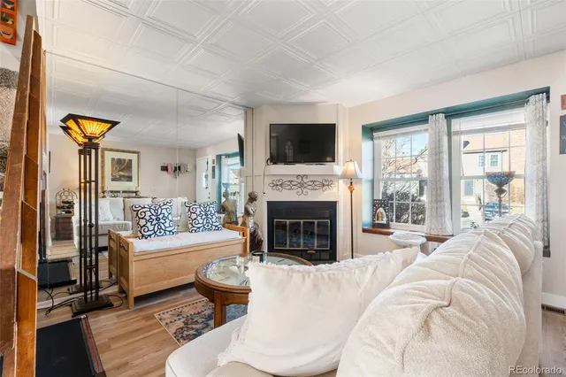 a living room with fireplace furniture and a flat screen tv