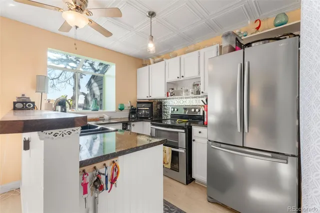 a kitchen with stainless steel appliances a refrigerator sink and cabinets