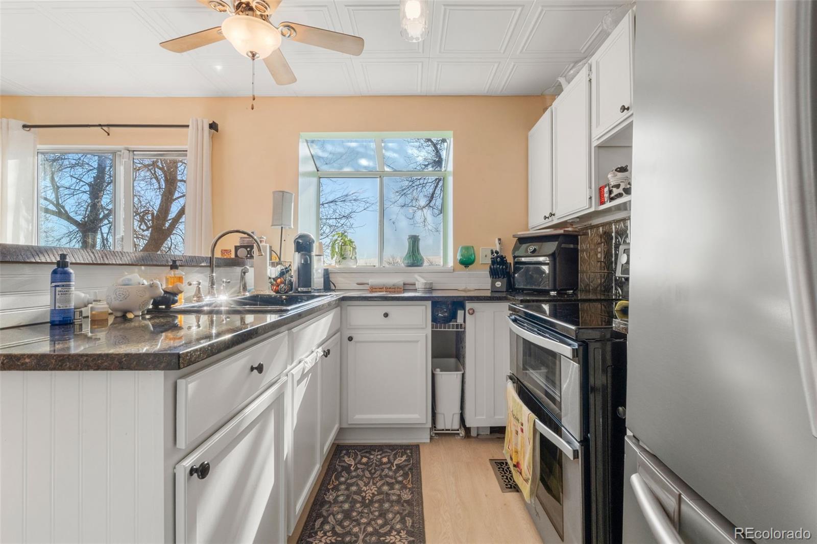 17467 East Rice Circle, Unit C Aurora, CO 80015 - Photo 9 of 25 a kitchen with a sink stove and microwave