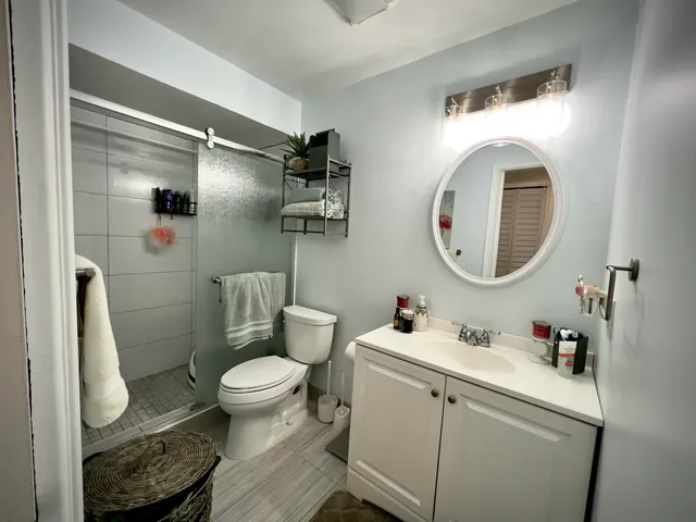 a bathroom with a toilet a sink and a mirror