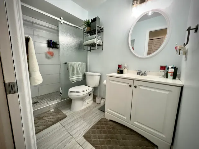 a bathroom with a sink mirror toilet and vanity