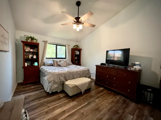 a bedroom with a bed and a flat screen tv