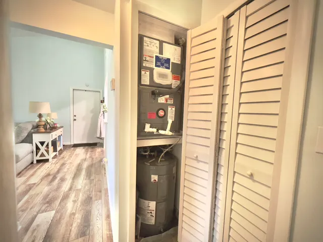 a view of a hallway and a livingroom with furniture