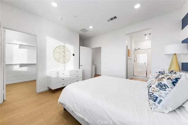 a bedroom with a bed a window and dresser