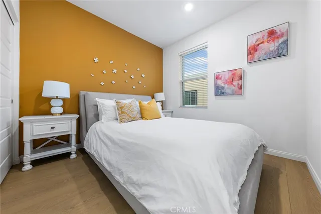 a bedroom with a bed and a painting on the wall