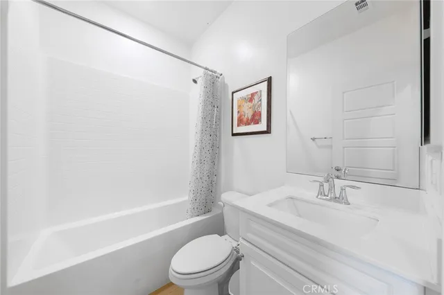 a white toilet sitting next to a bath tub