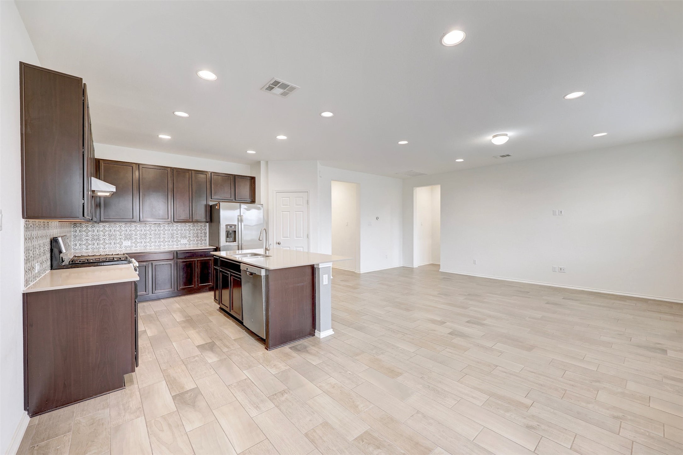 307 Simmental Loop Hutto, TX 78634 - Photo 15 of 34 A contemporary open-concept layout unites the sleek kitchen with the versatile living space.