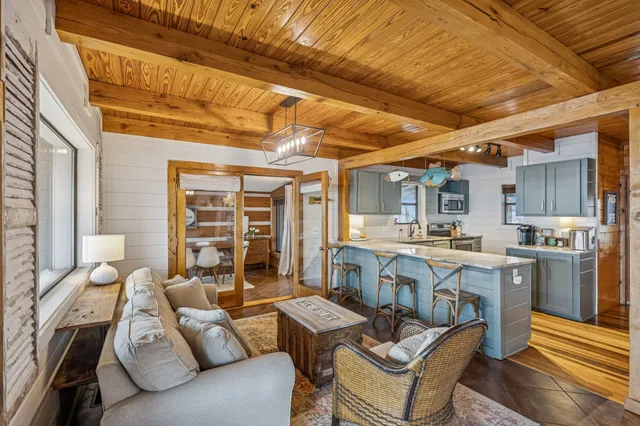 a living room with furniture and kitchen view