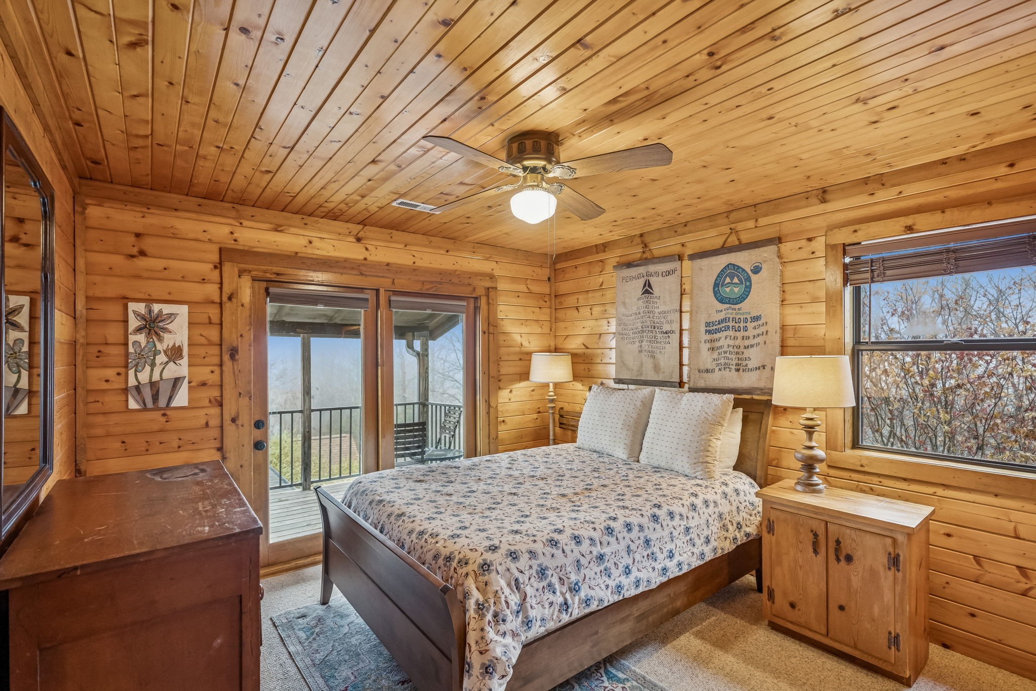 289 Dunn Ridge Road Baxter, TN 38544 - Photo 18 of 42 a bedroom with a large bed a chandelier and dresser