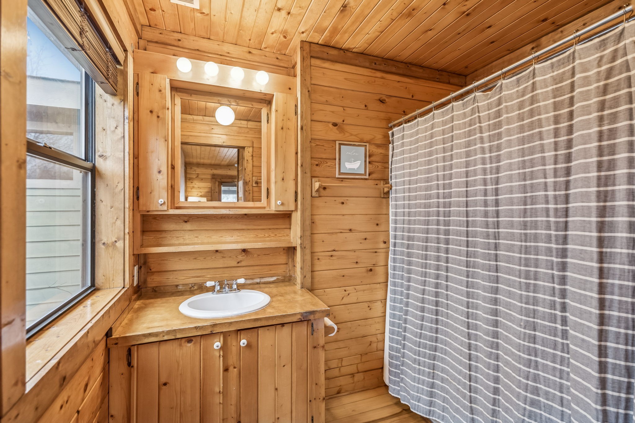 289 Dunn Ridge Road Baxter, TN 38544 - Photo 19 of 42 a bathroom with a sink a mirror and shower