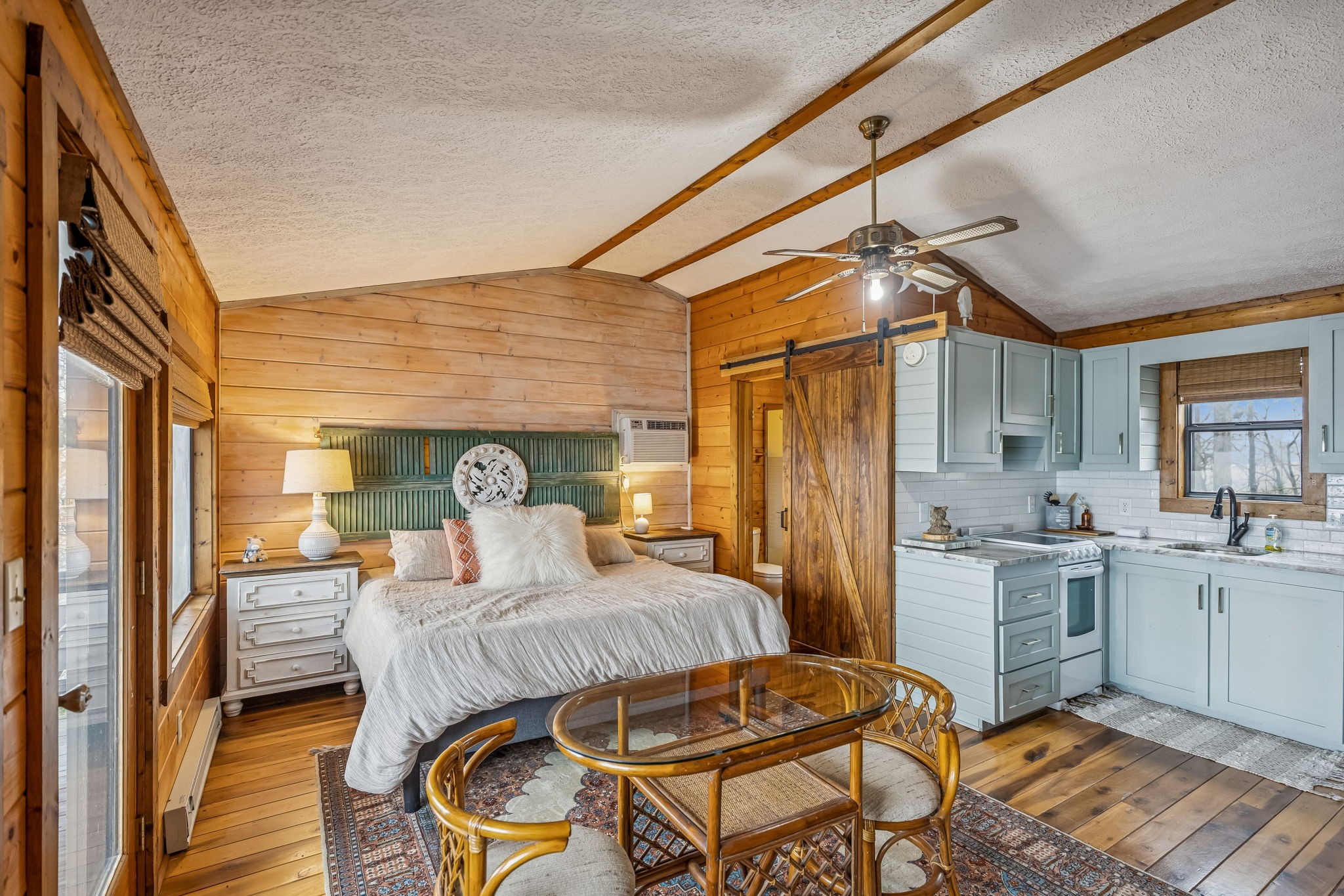 289 Dunn Ridge Road Baxter, TN 38544 - Photo 30 of 42 a bedroom with a bed and wooden floors