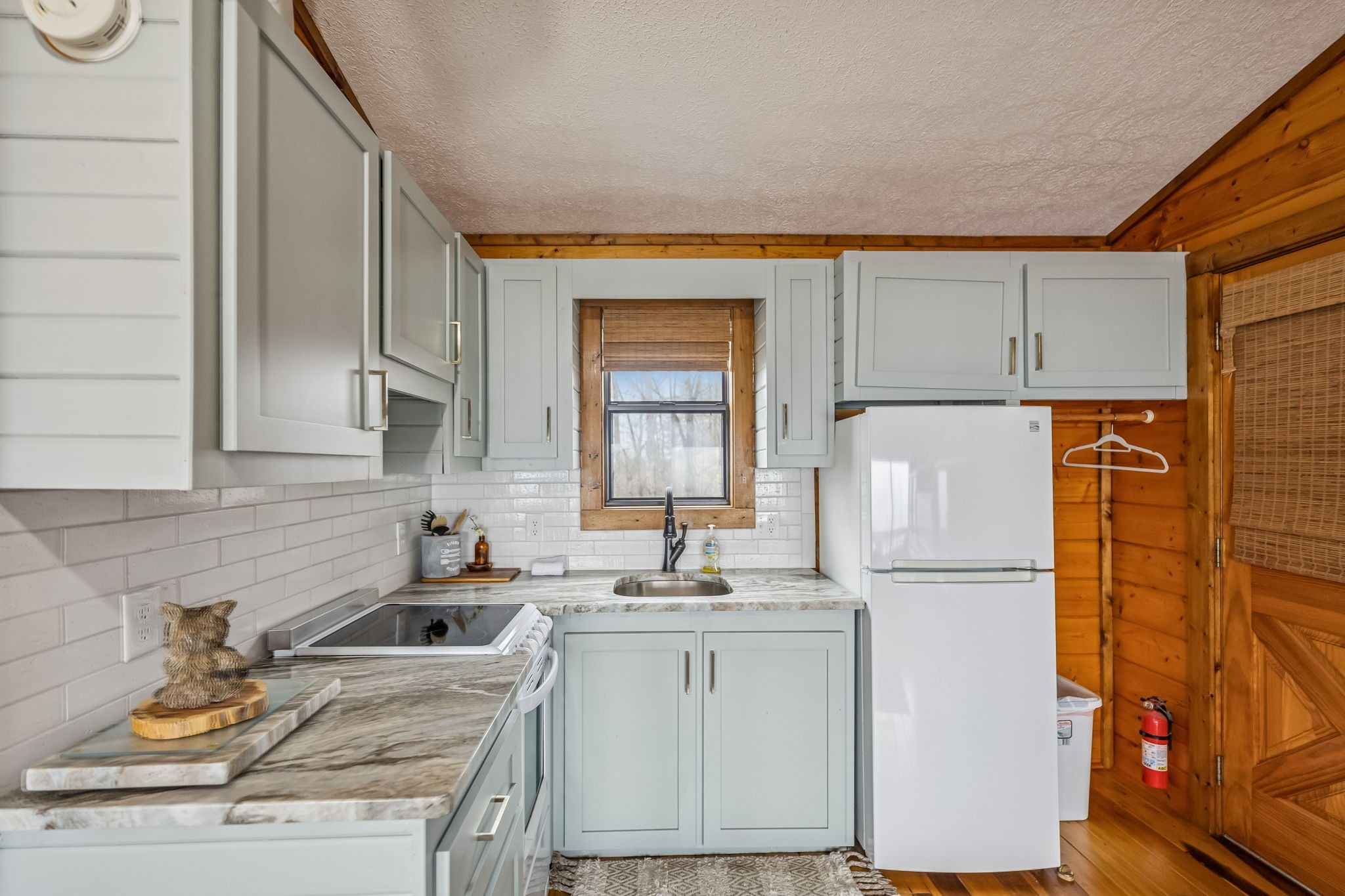 289 Dunn Ridge Road Baxter, TN 38544 - Photo 33 of 42 a kitchen with a refrigerator sink stove and cabinets