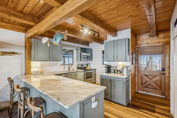 a kitchen with a stove a sink and a refrigerator
