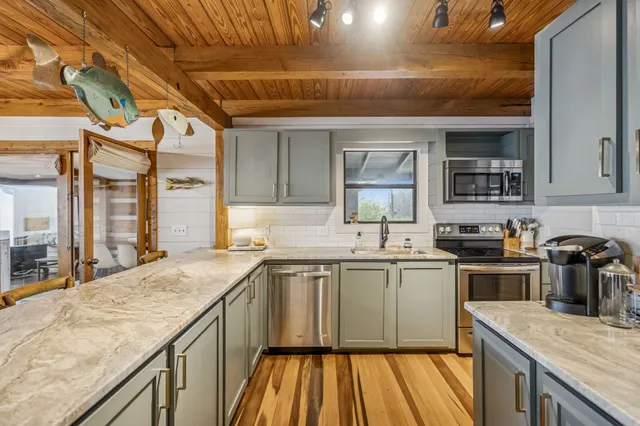 a kitchen with a sink stove and cabinets