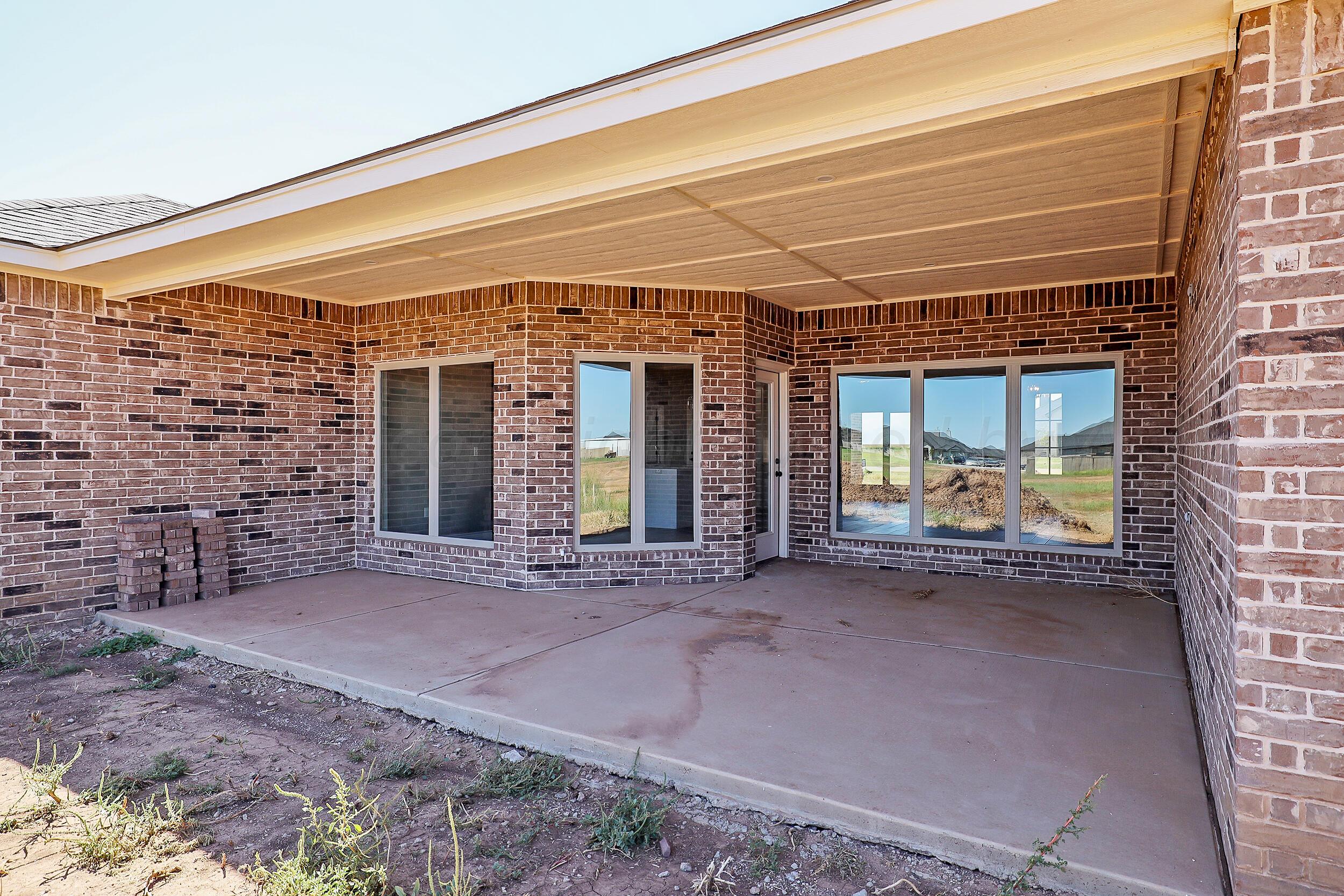 9551 Trinity Drive Amarillo, TX 79119 - Photo 16 of 46 a view of a brick building with an outdoor space