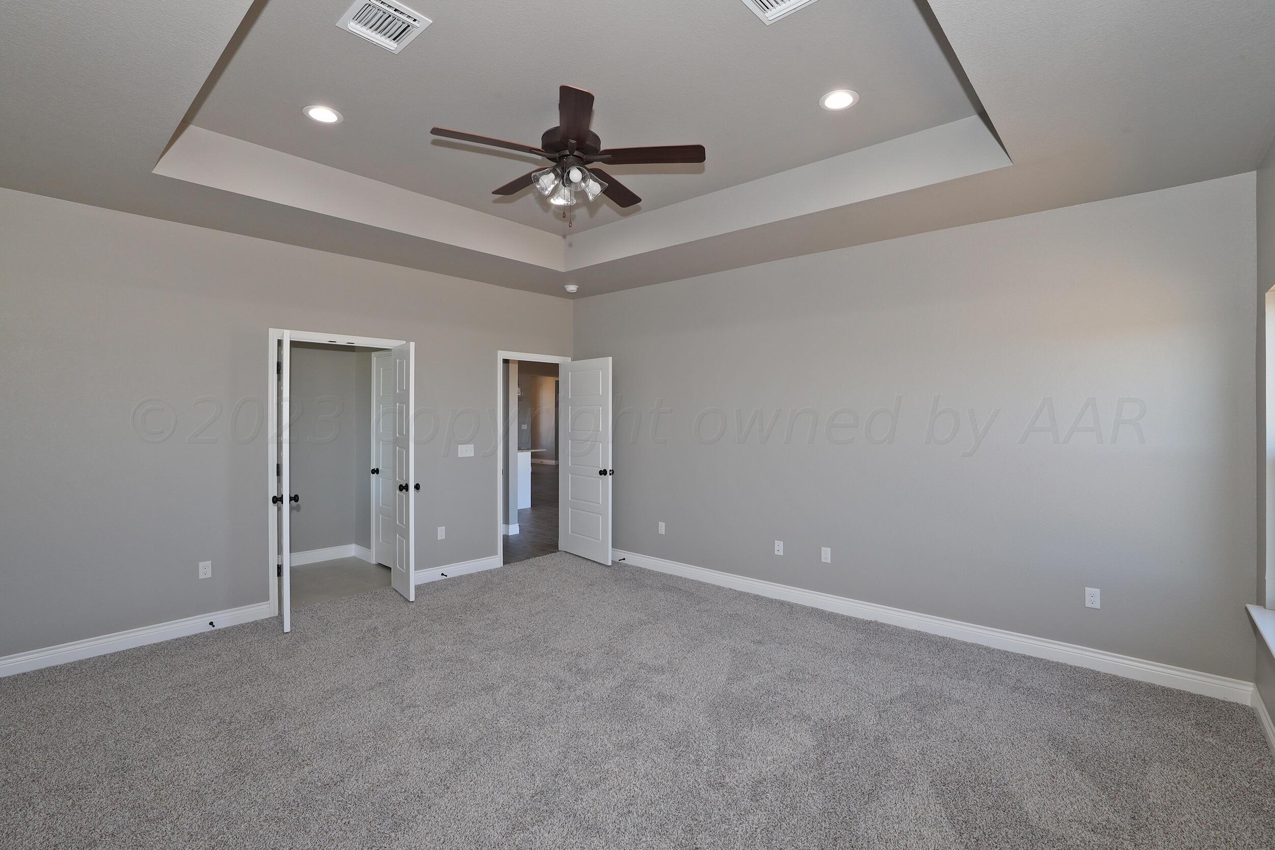 9551 Trinity Drive Amarillo, TX 79119 - Photo 20 of 46 a view of an empty room with a ceiling fan
