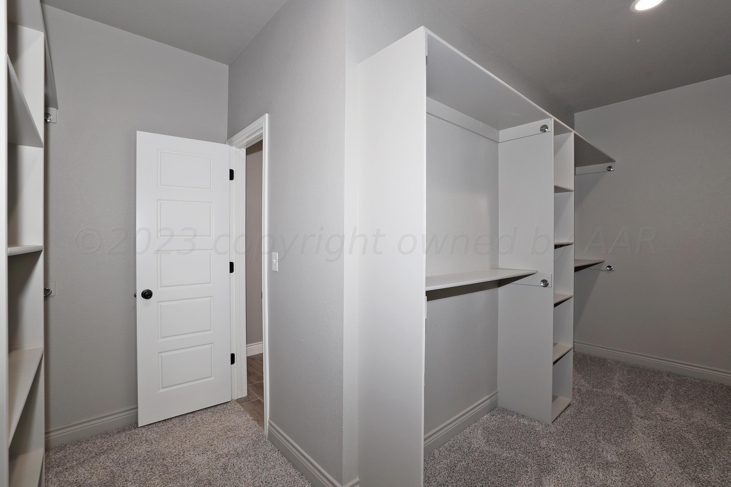 9551 Trinity Drive Amarillo, TX 79119 - Photo 22 of 46 a view of walk in closet with empty racks