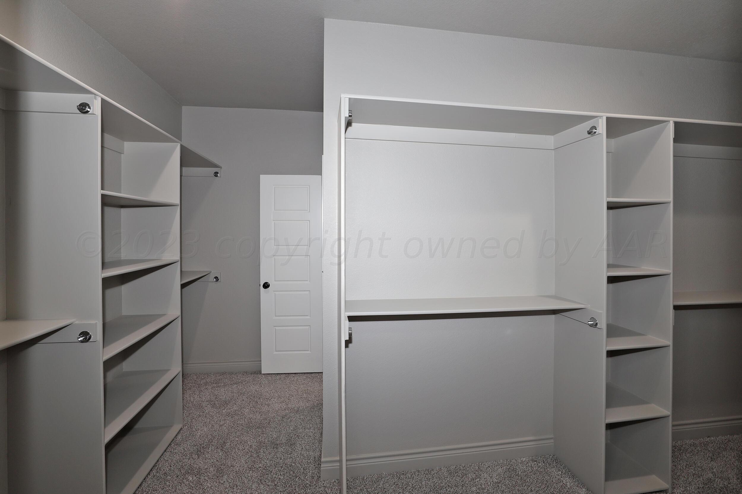 9551 Trinity Drive Amarillo, TX 79119 - Photo 23 of 46 a view of walk in closet with empty racks