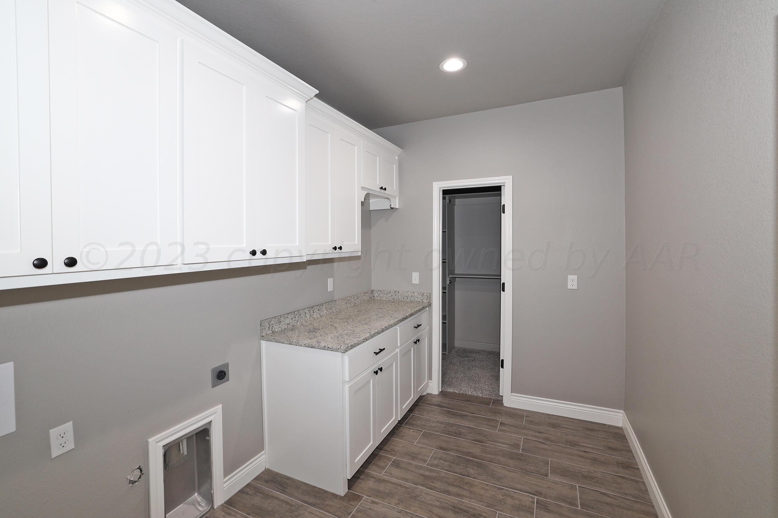 9551 Trinity Drive Amarillo, TX 79119 - Photo 24 of 46 a kitchen with a sink and cabinets
