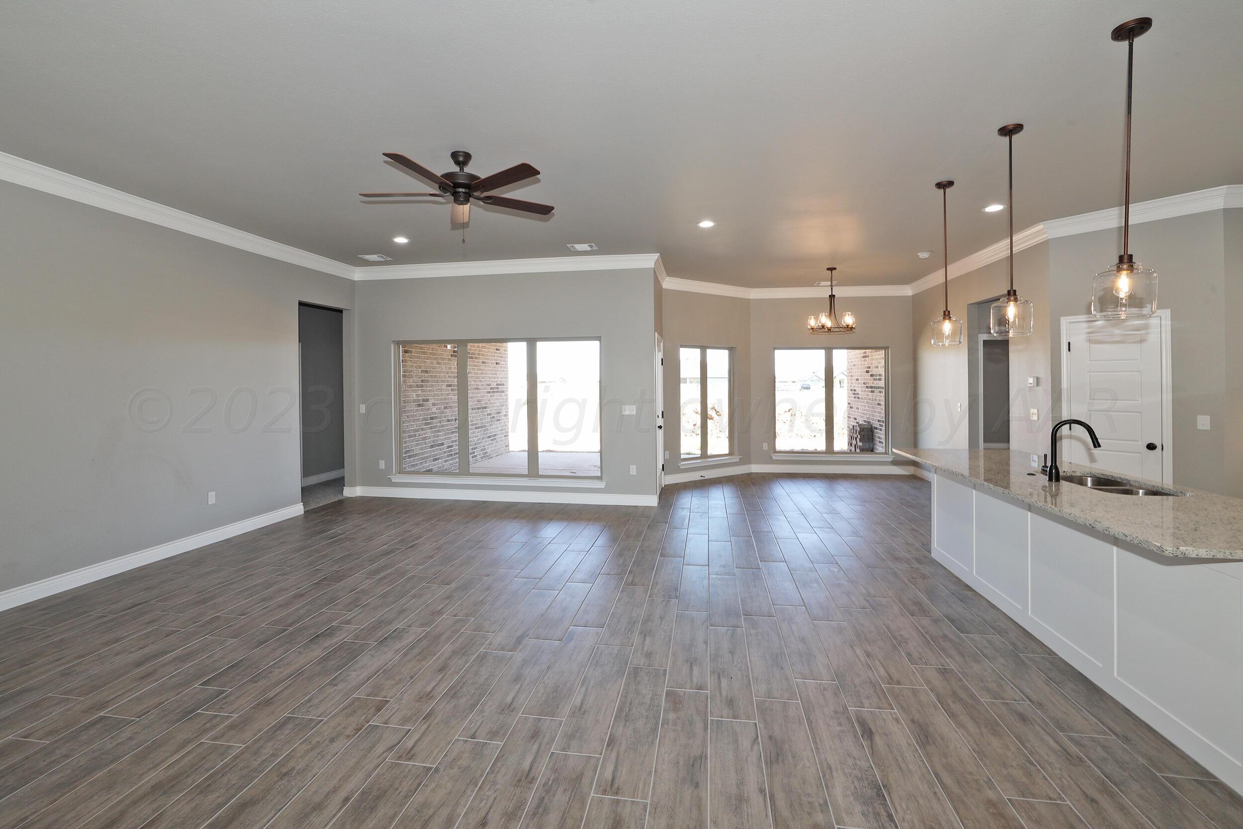 9551 Trinity Drive Amarillo, TX 79119 - Photo 3 of 46 a view of a room with wooden floor and a ceiling fan