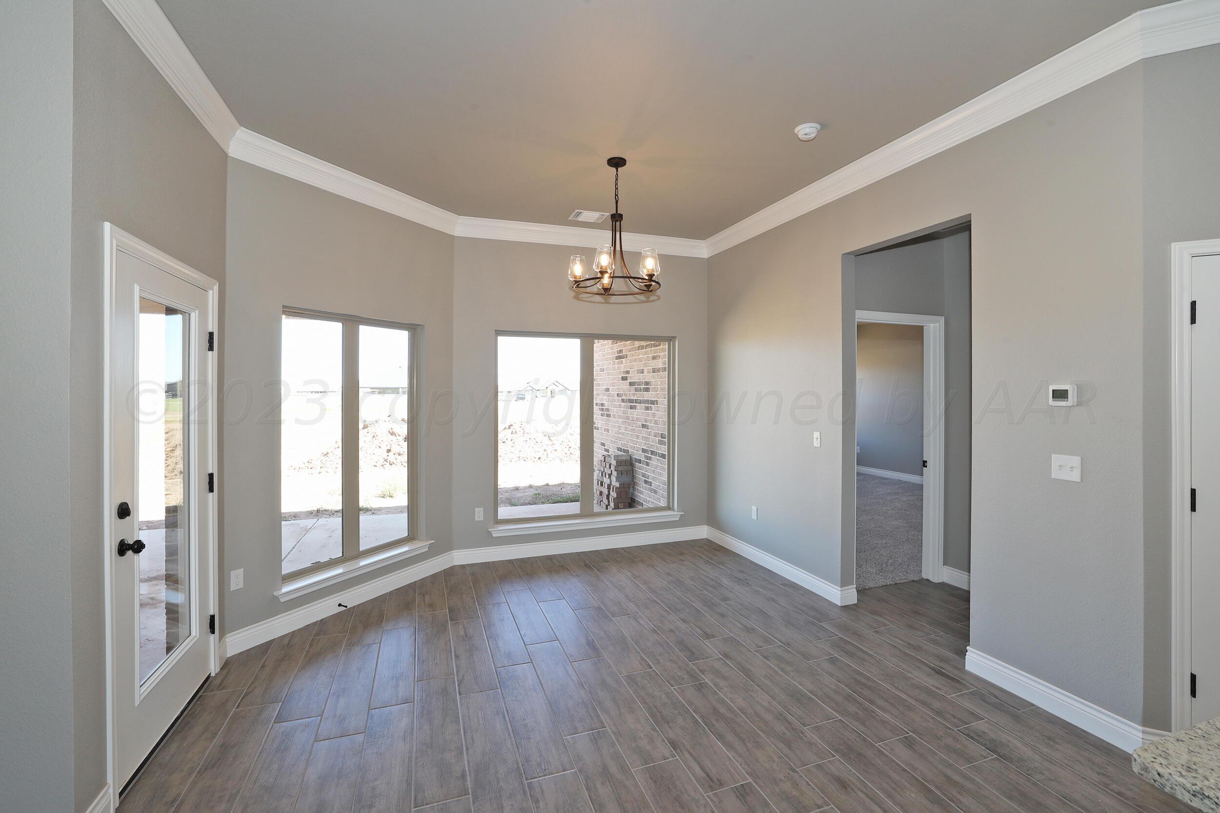 9551 Trinity Drive Amarillo, TX 79119 - Photo 31 of 46 wooden floor in an empty room with a window