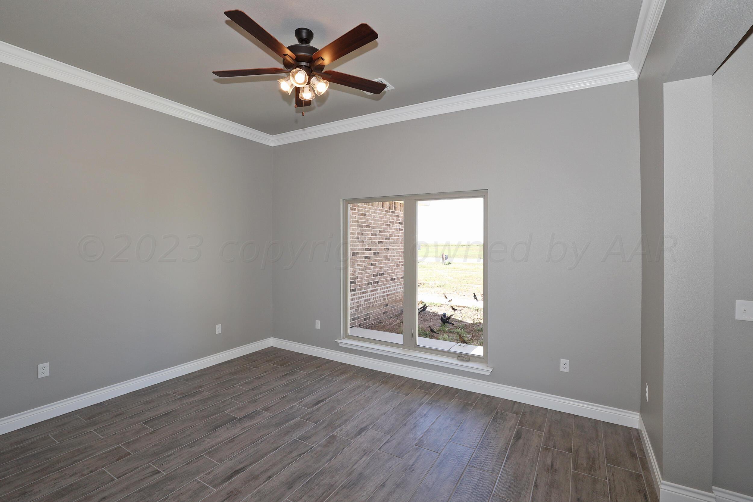9551 Trinity Drive Amarillo, TX 79119 - Photo 33 of 46 wooden floor in an empty room with a window