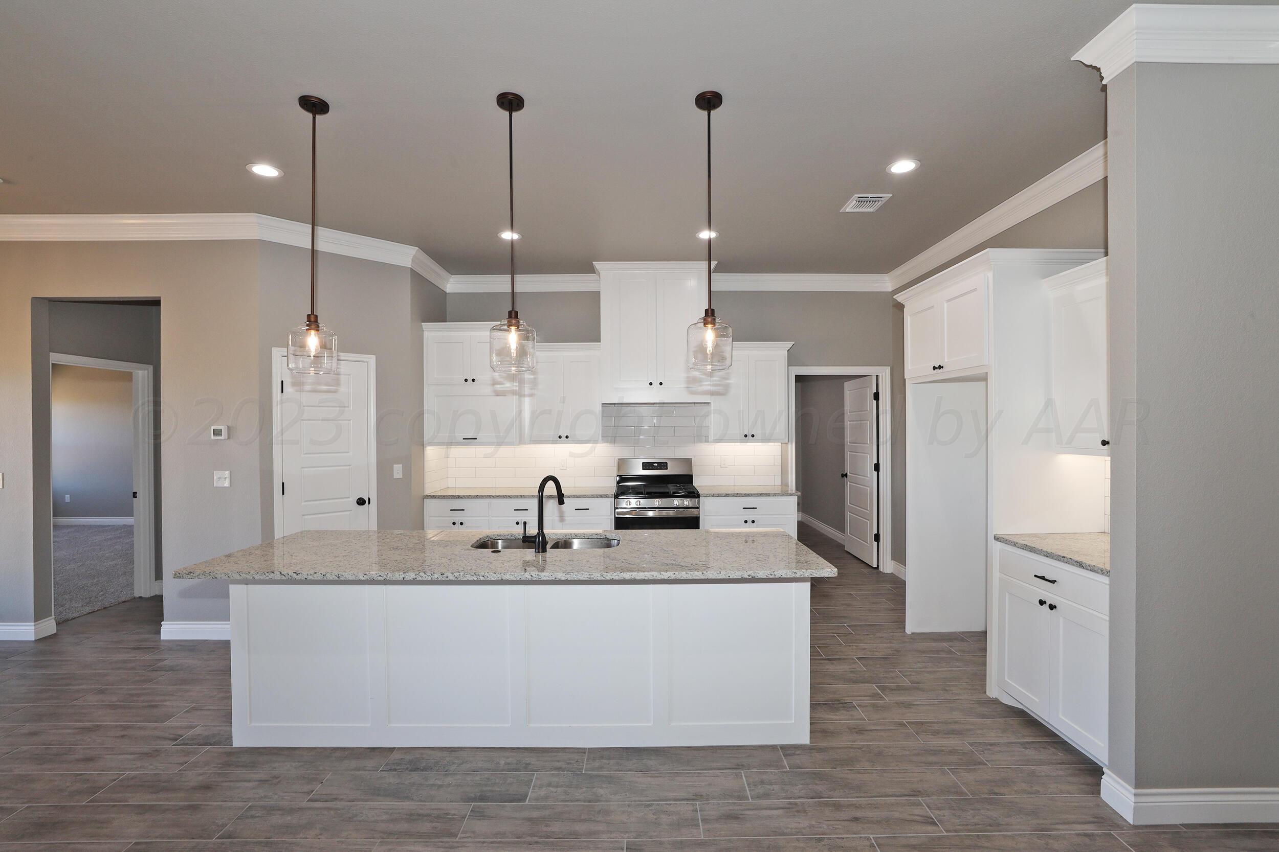 9551 Trinity Drive Amarillo, TX 79119 - Photo 38 of 46 a large white kitchen with stainless steel appliances