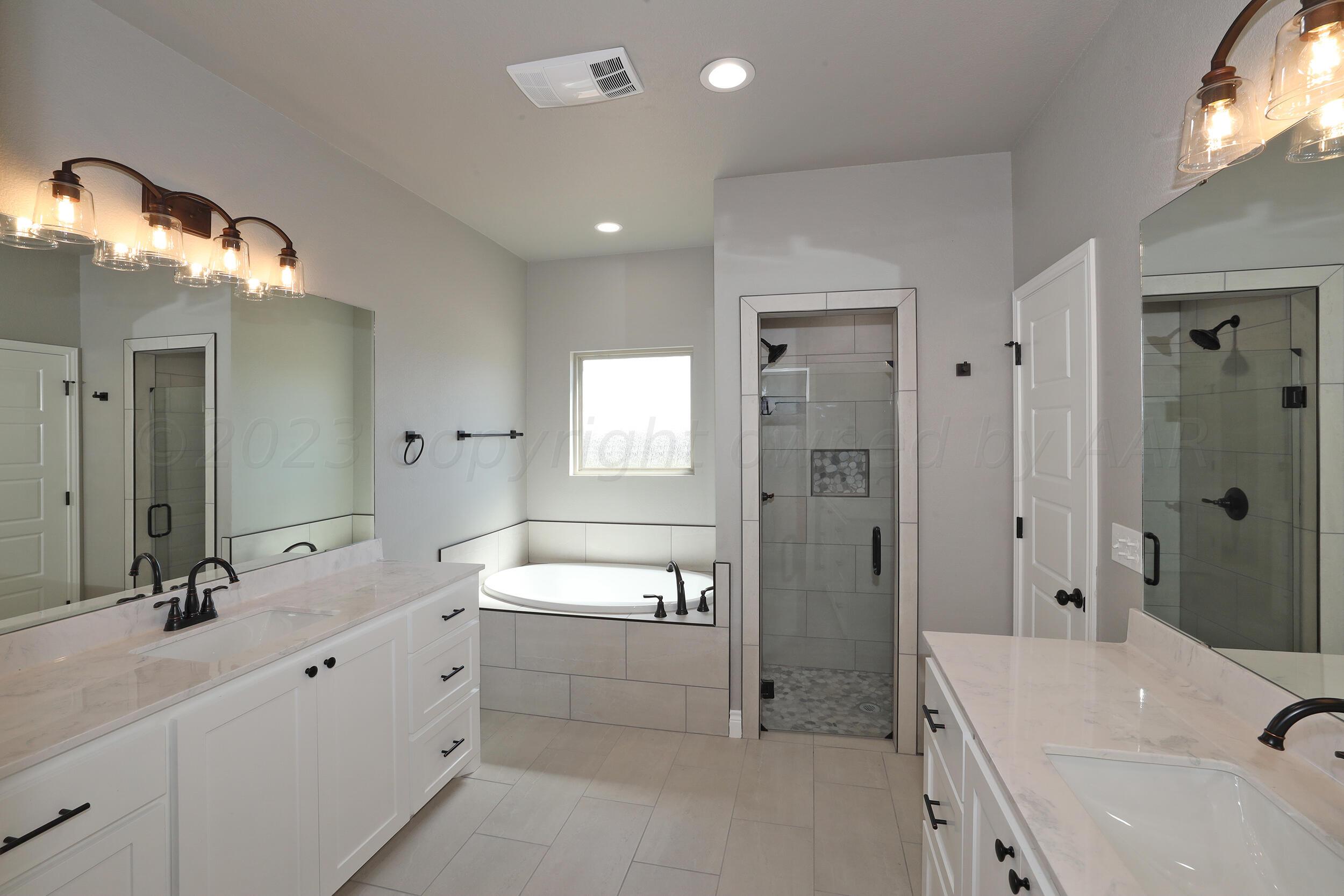 9551 Trinity Drive Amarillo, TX 79119 - Photo 39 of 46 a bathroom with a double vanity sink mirror double and shower