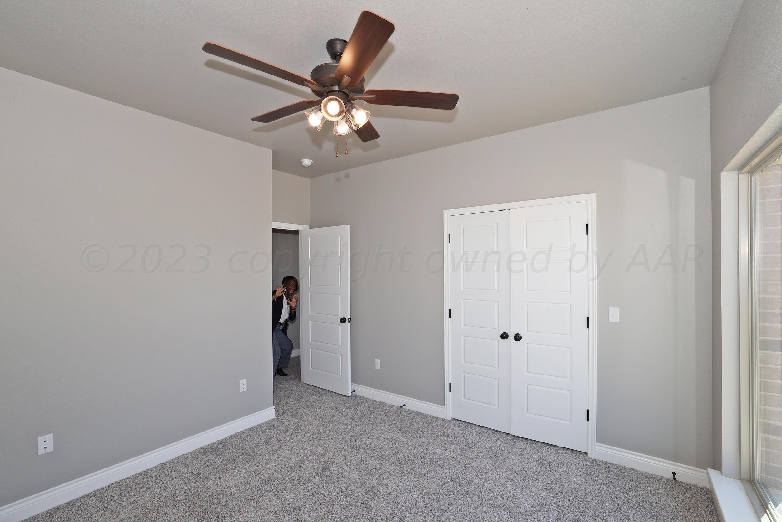 9551 Trinity Drive Amarillo, TX 79119 - Photo 41 of 46 an empty room with closet and a chandelier fan