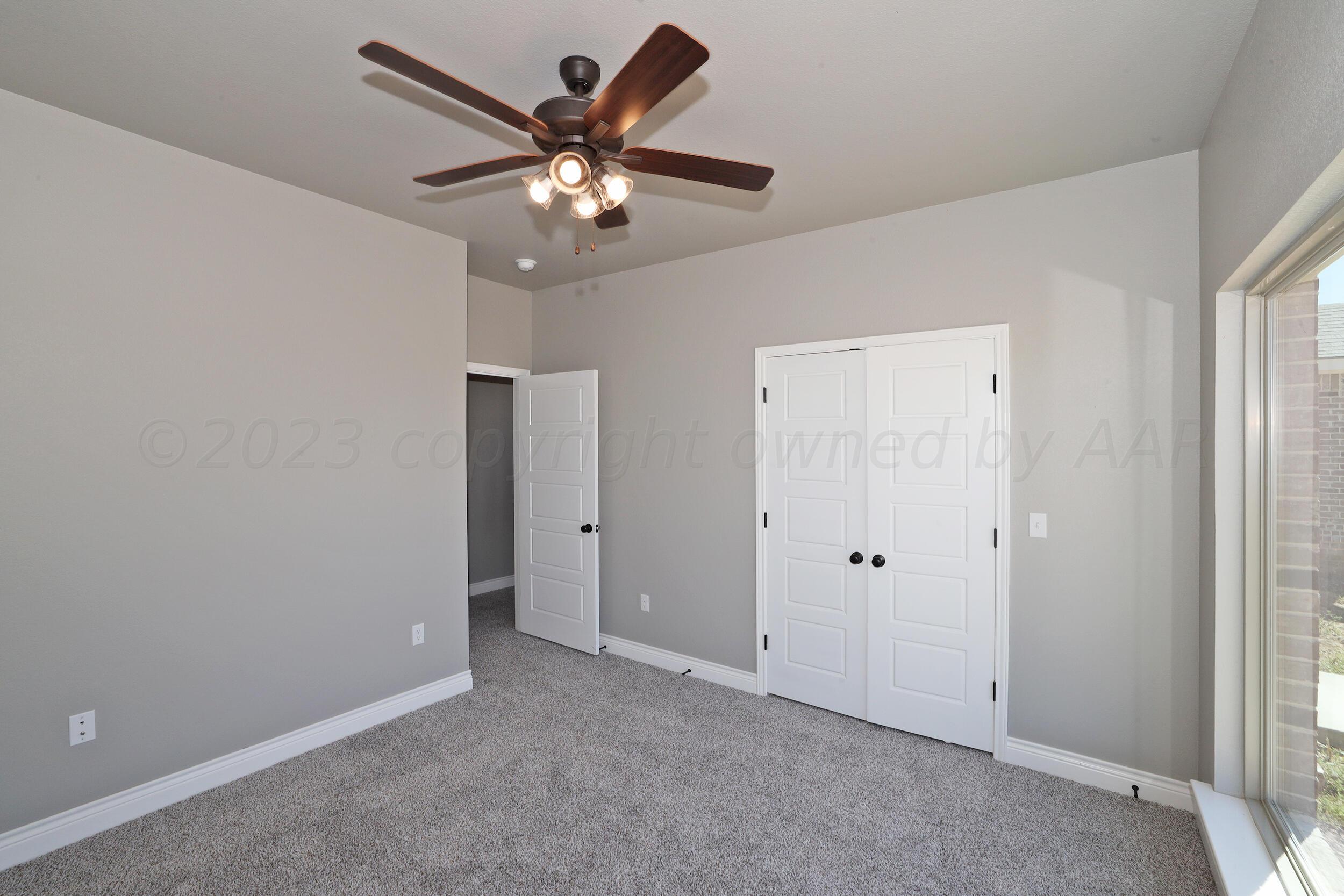 9551 Trinity Drive Amarillo, TX 79119 - Photo 43 of 46 an empty room with a chandelier fan