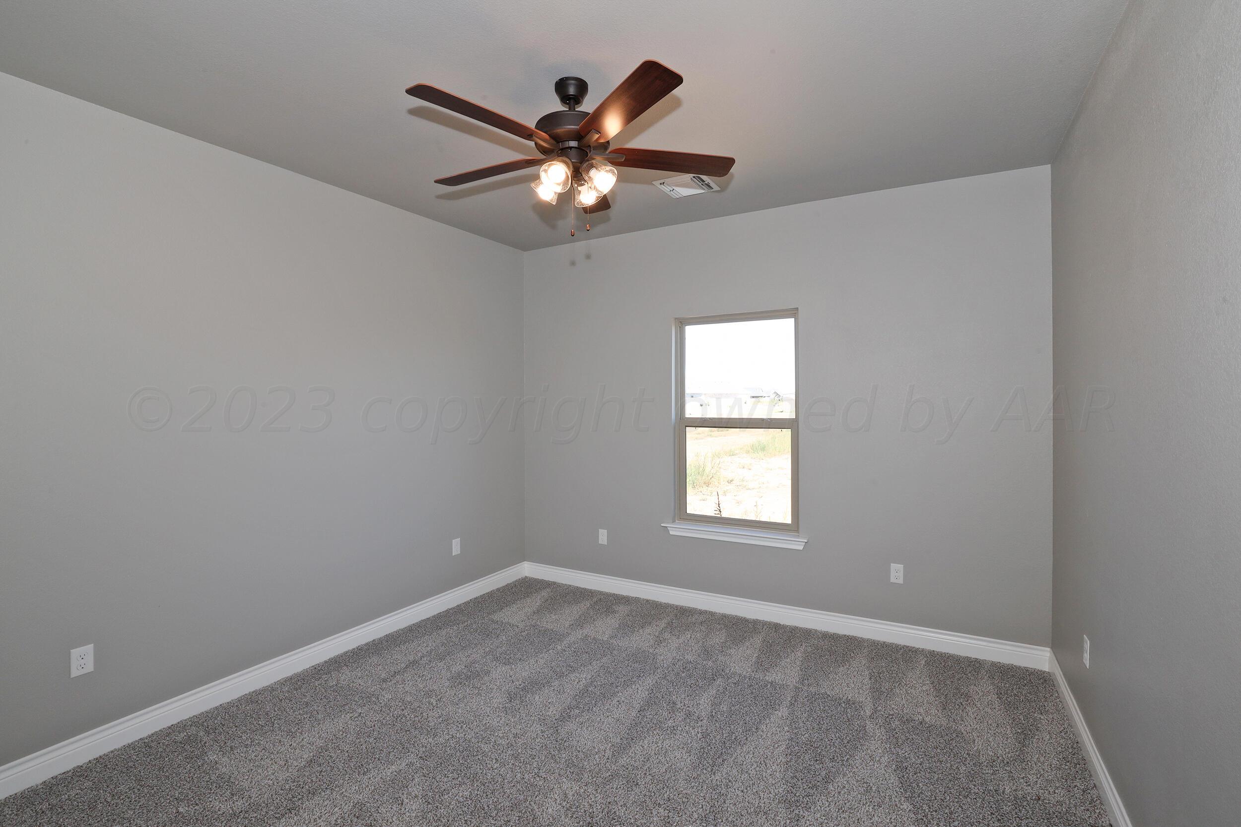 9551 Trinity Drive Amarillo, TX 79119 - Photo 44 of 46 an empty room with windows and fan