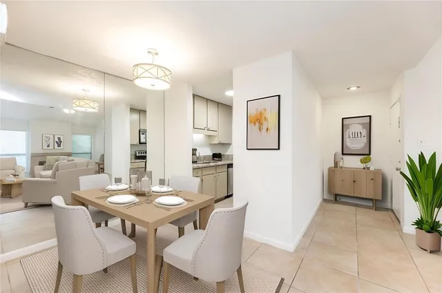 a view of a dining room with furniture and a potted plant