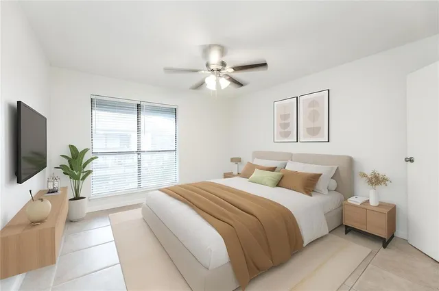 an empty room with windows and fan