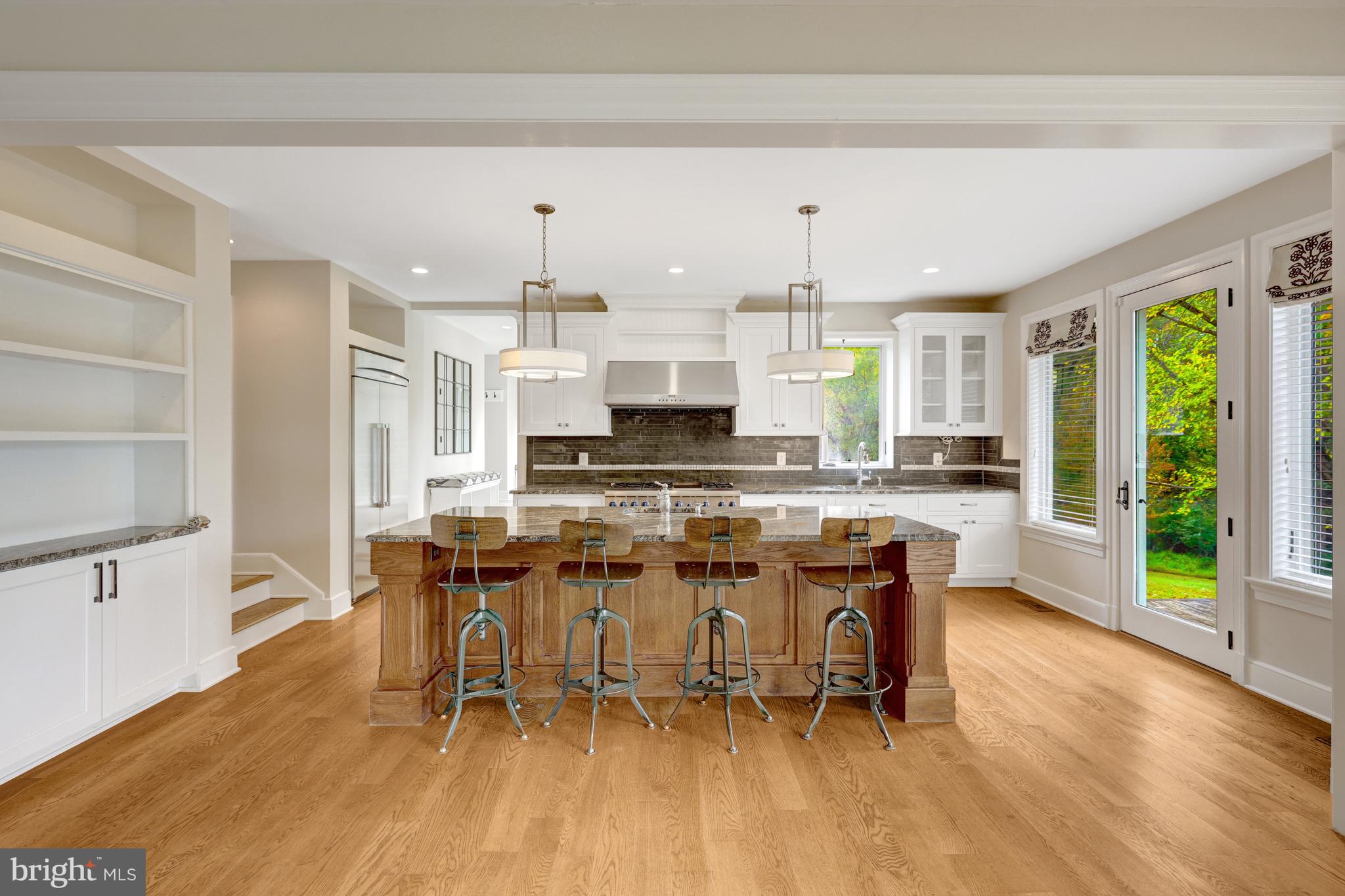 440 Montpelier Road Great Falls, VA 22066 - Photo 16 of 79 a large kitchen with a table and chairs in it