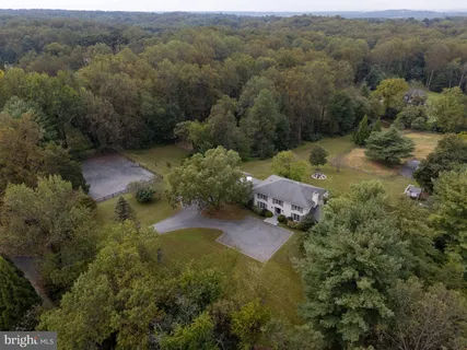 an aerial view of a house with a yard and lake view