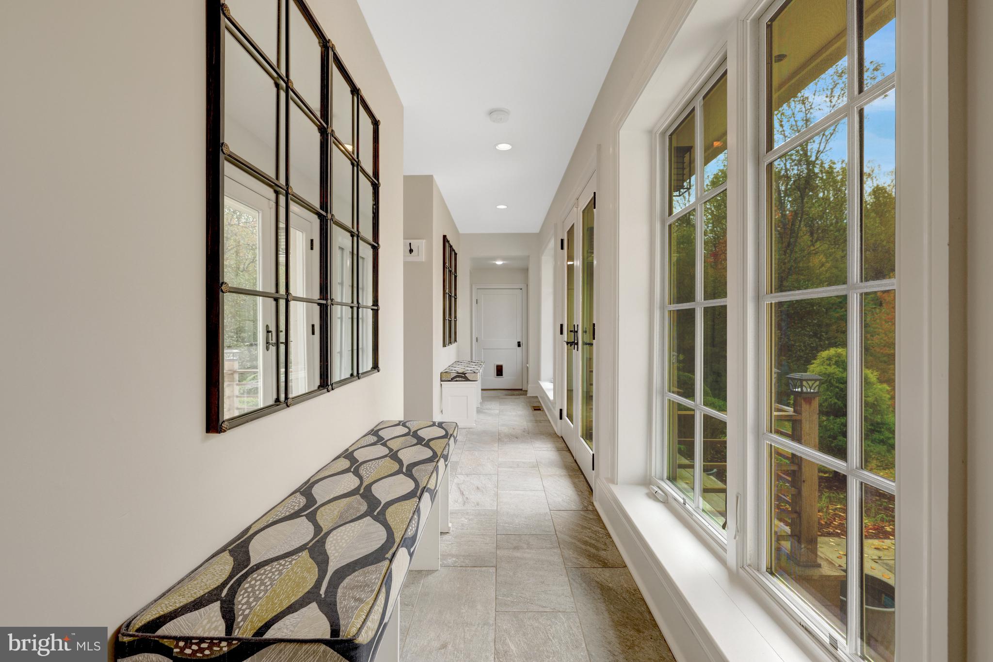 440 Montpelier Road Great Falls, VA 22066 - Photo 33 of 79 a view of staircase with lots of frames on wall and a large window