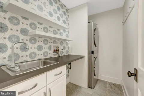 a view of an empty room with a chandelier fan