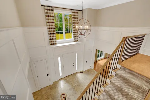 a view of house with garden and trees in the background