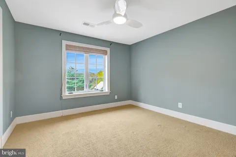 a view of a house with a yard and tree