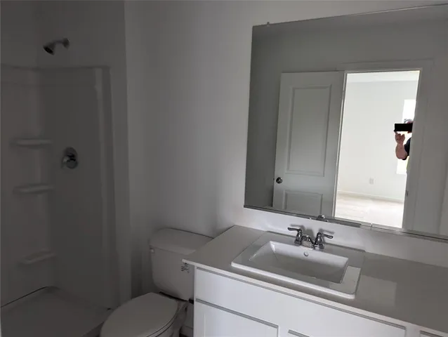 a bathroom with a sink toilet and vanity
