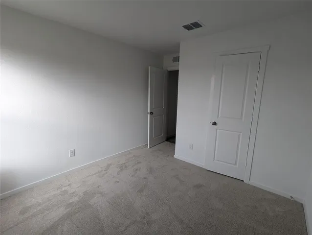 a kitchen with a refrigerator sink and cabinets