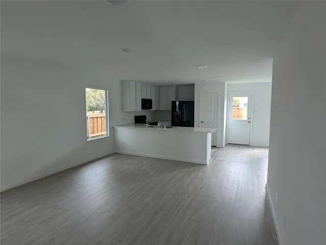 a room with a sink a bed and a mirror