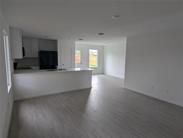 a view of a kitchen with a sink dishwasher and a refrigerator