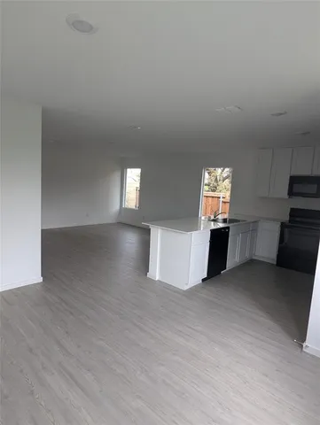 a view of an empty room and a window