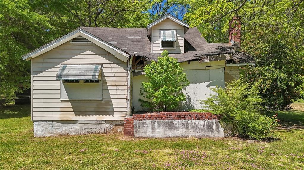 5735 Old Bill Cook Road Atlanta, GA 30349 - Photo 12 of 38 a front view of a house with a yard